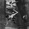 22/7/1975, Boston, USA. Stanley Forman, USA, Boston Herald. A mother and her daughter are hurled off a collapsing fire-escape in an apartment house fire. Together with a fire-fighter, they waited for the rescue ladder to reach them. As the fire-fighter climbed onto the ladder, the fire-escape collapsed under their feet and they fell to the ground five floors below. The woman was killed but the child survived, her fall cushioned by the woman's body.