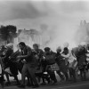 8/1977, South Africa. Leslie Hammond, South Africa, The Argus. Police throw tear-gas at a group of chanting residents of the Modderdam squatter camp protesting against the demolition of their homes outside Cape Town.