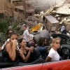 15/8/2006, Beirut, Lebanon. Spencer Platt, USA, Getty Images. Young Lebanese drive down a street in Haret Hreik, a bombed neighborhood in southern Beirut. For nearly five weeks Israel had been targeting that part of the city and towns across southern Lebanon in a campaign against Hezbollah militants. As a ceasefire gradually came into force from August 14, thousands of Lebanese began to return to their homes. According to the Lebanese government, 15,000 homes and 900 commercial concerns were damaged.